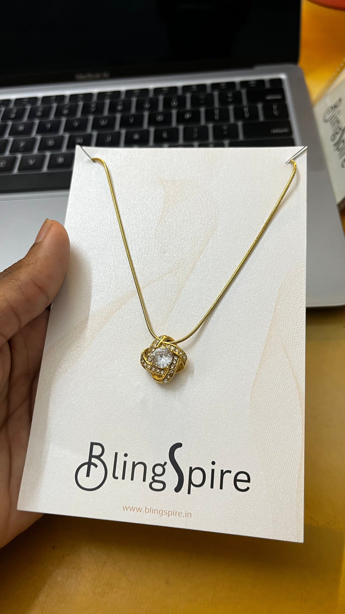 Eternal Elegance: Gold-Tone Knot Pendant Necklace