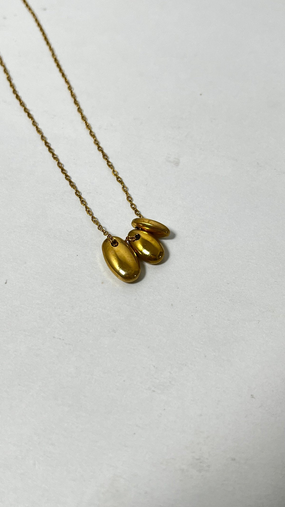 Minimalist Magic: Gold-Tone Pebble Necklace